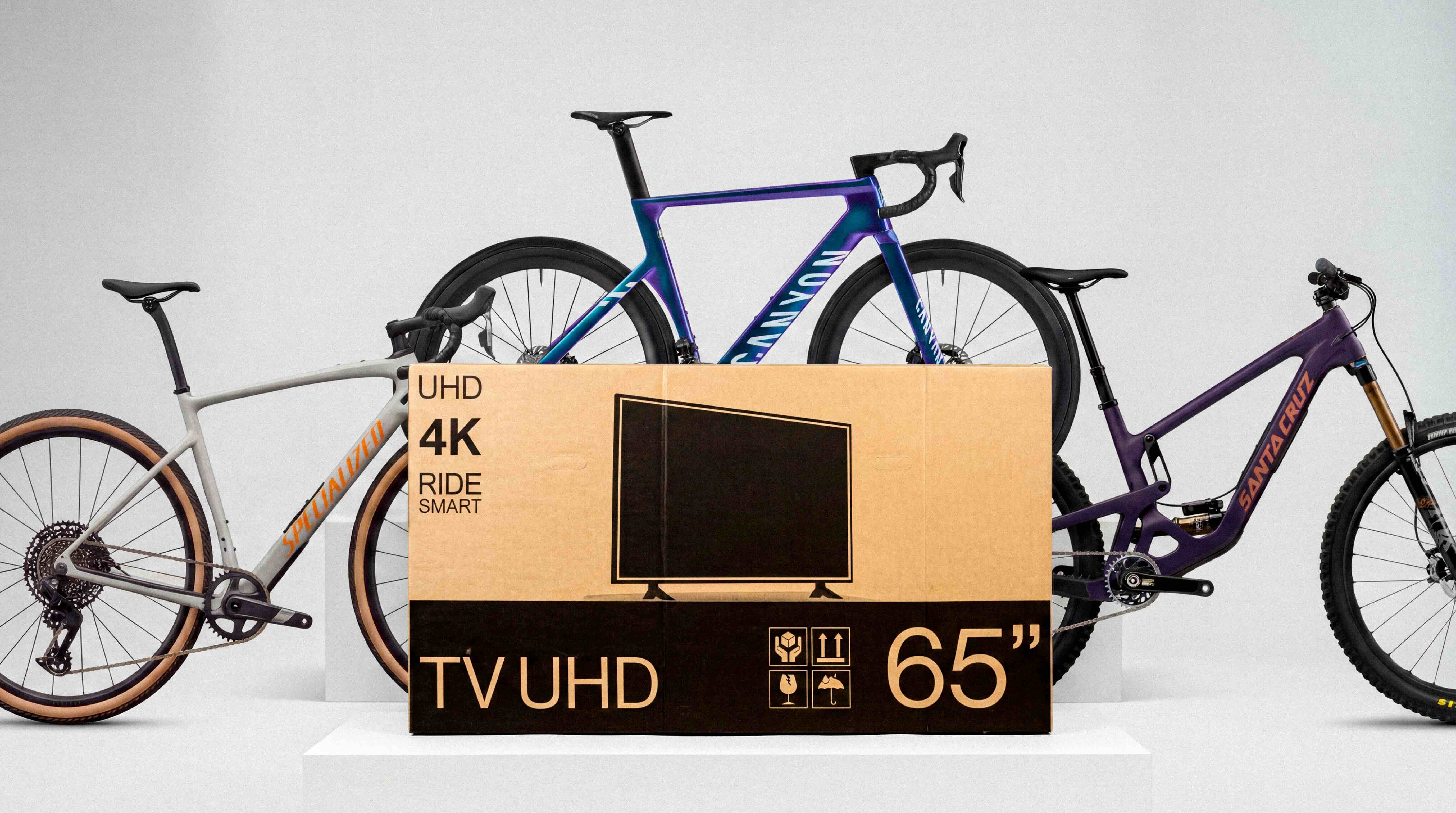 Three bikes alongside a buycycle TV-box style shipping box